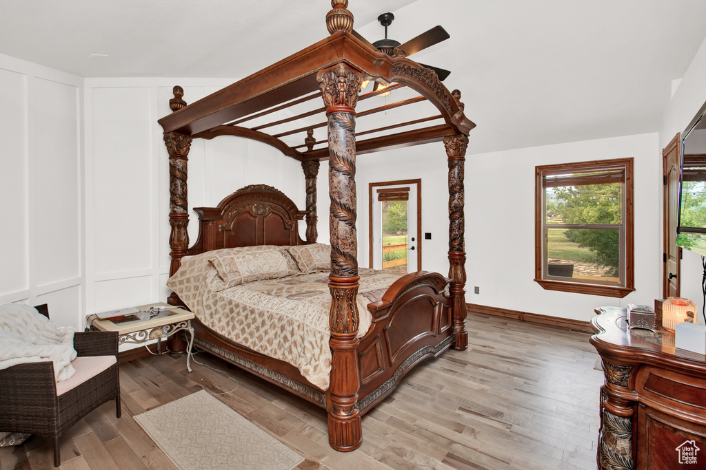 Bedroom with light hardwood / wood-style flooring, access to outside, ceiling fan, and lofted ceiling