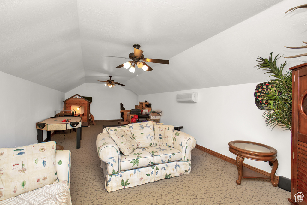 Interior space featuring vaulted ceiling, a wall unit AC, ceiling fan, and light colored carpet