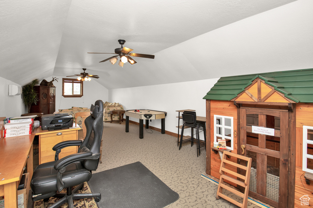 Carpeted office space featuring ceiling fan and lofted ceiling