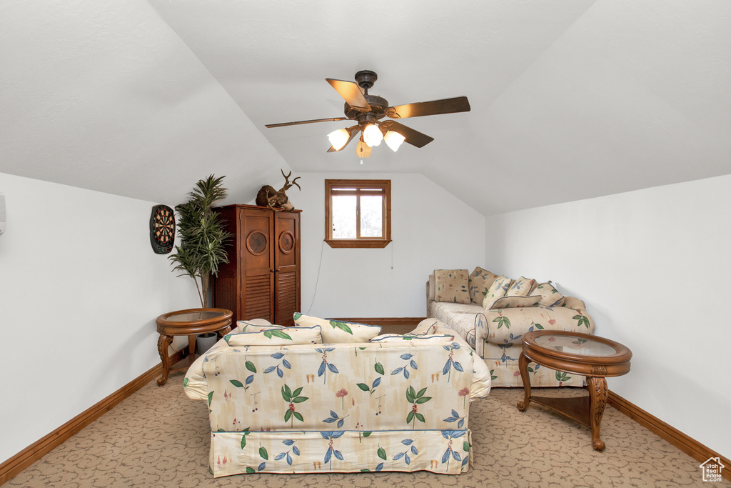 Bedroom featuring lofted ceiling, ceiling fan, and light carpet