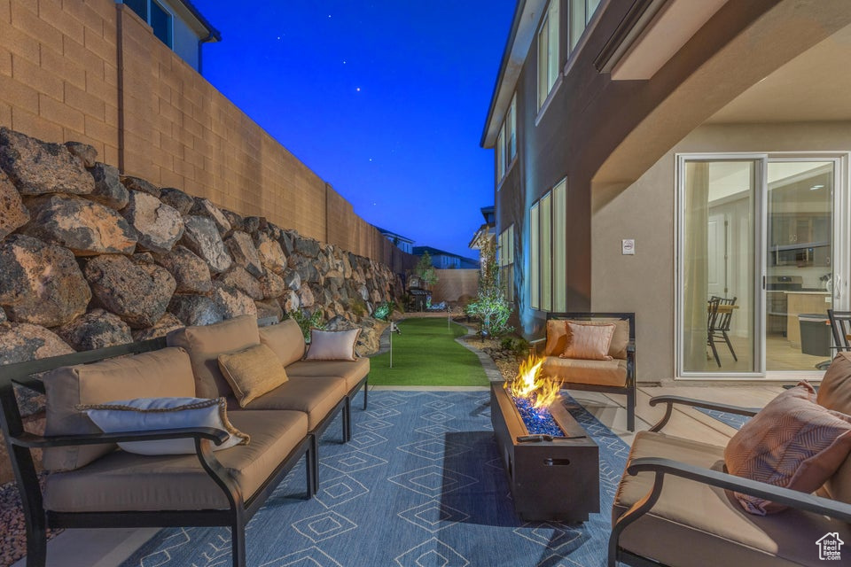 Patio terrace at twilight featuring an outdoor living space with a fire pit