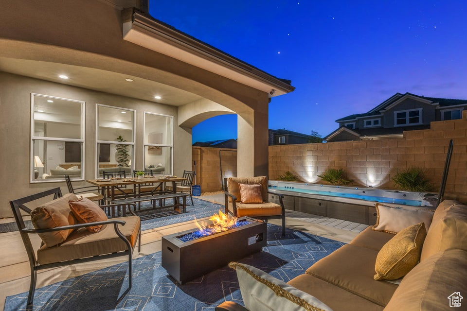 View of patio featuring an outdoor living space with a fire pit