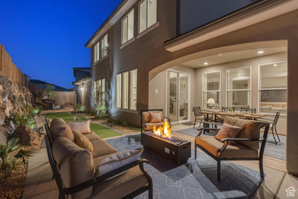 Patio terrace at twilight featuring an outdoor living space with a fire pit
