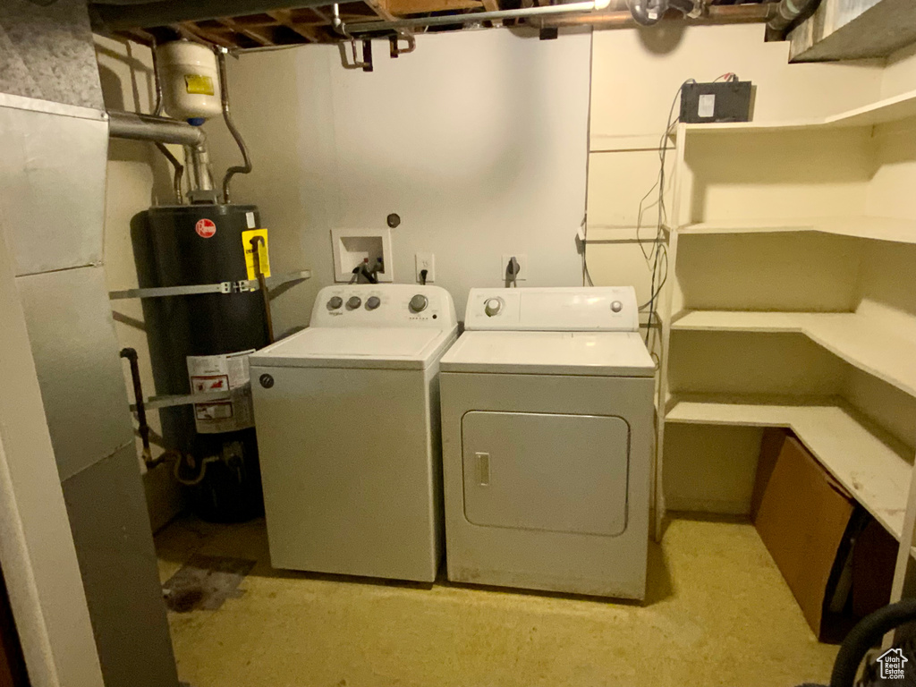 Laundry room featuring washer hookup, separate washer and dryer, and strapped water heater