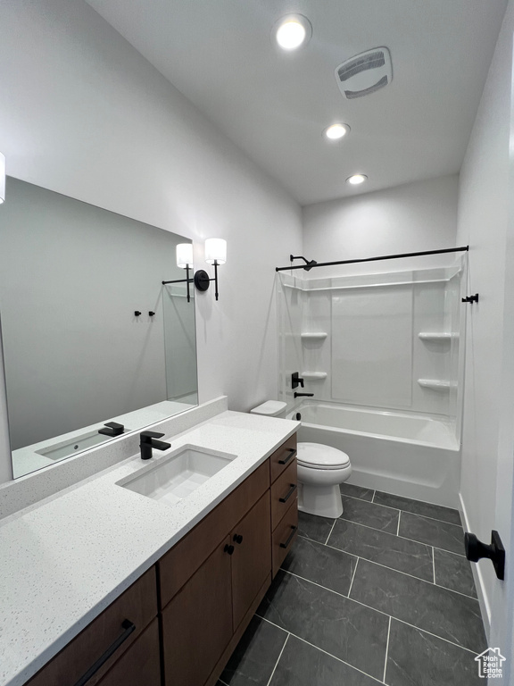Full bathroom with toilet, shower / bathtub combination, large vanity, and tile flooring