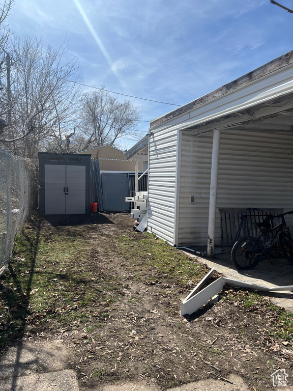 View of yard featuring a storage unit