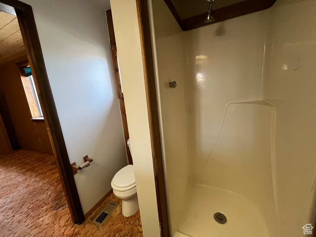 Bathroom featuring toilet and walk in shower
