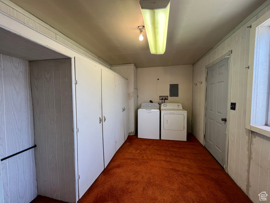 Laundry area with washing machine and clothes dryer, dark colored carpet, and hookup for a washing machine