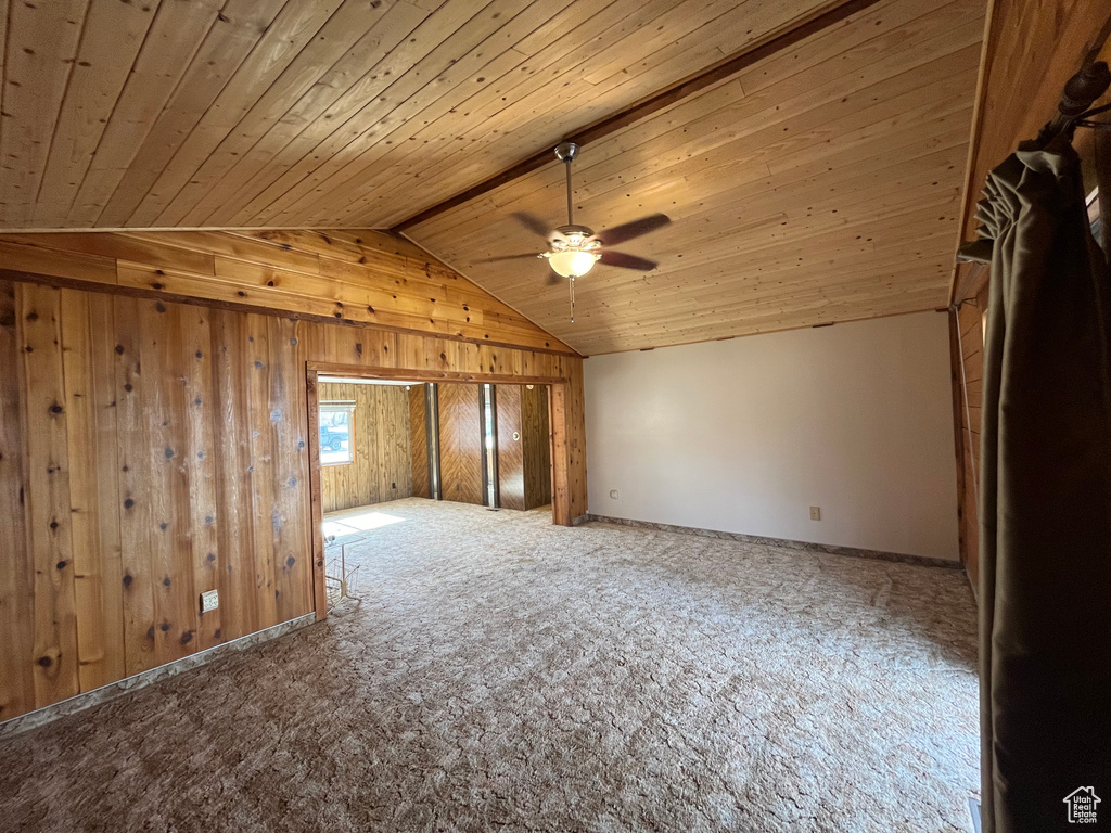 Additional living space with wooden ceiling, ceiling fan, and carpet