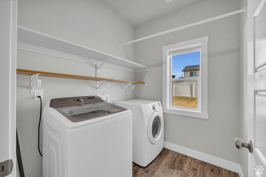 Washroom featuring dark hardwood / wood-style flooring and independent washer and dryer
