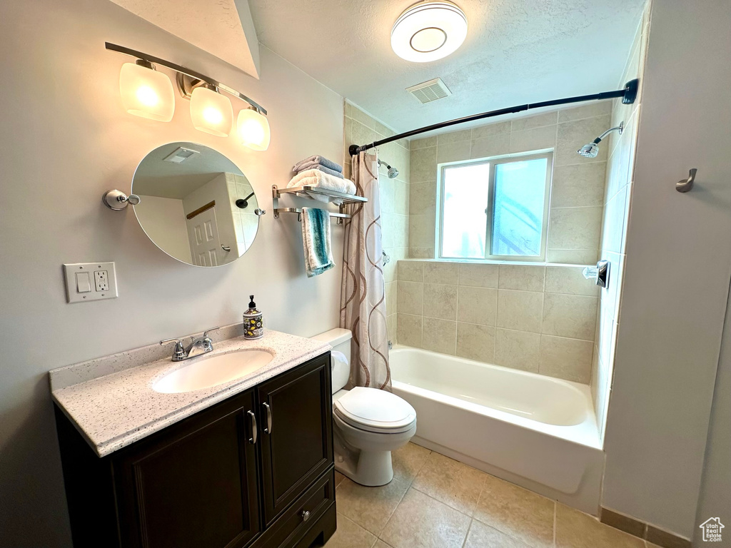 Full bathroom with vanity, shower / bath combination with curtain, tile floors, and toilet