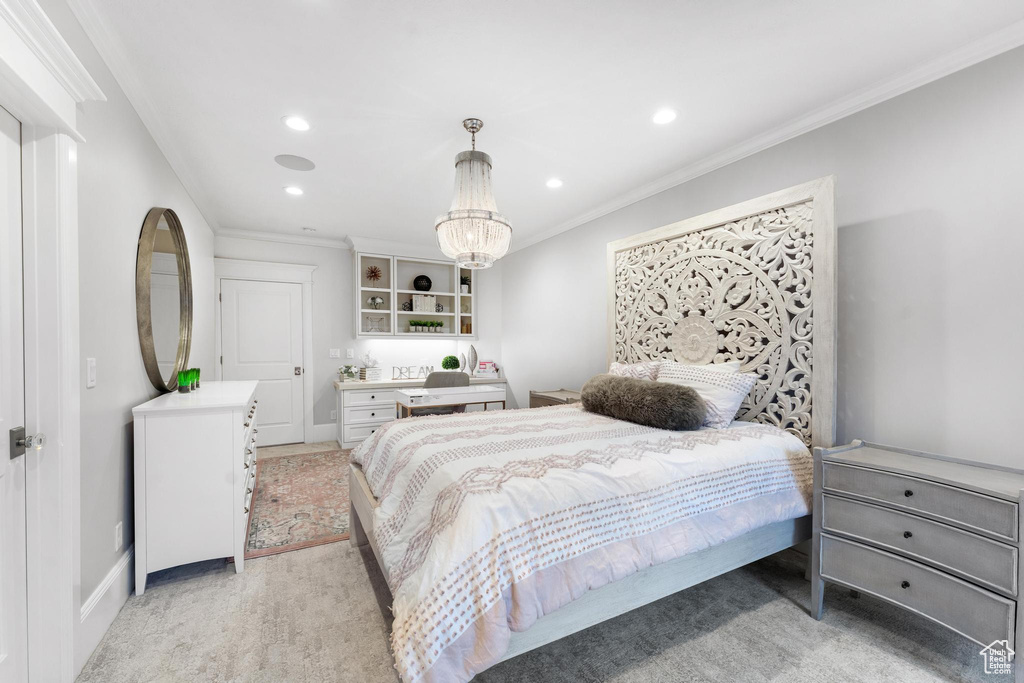 Bedroom with a notable chandelier, light colored carpet, and ornamental molding