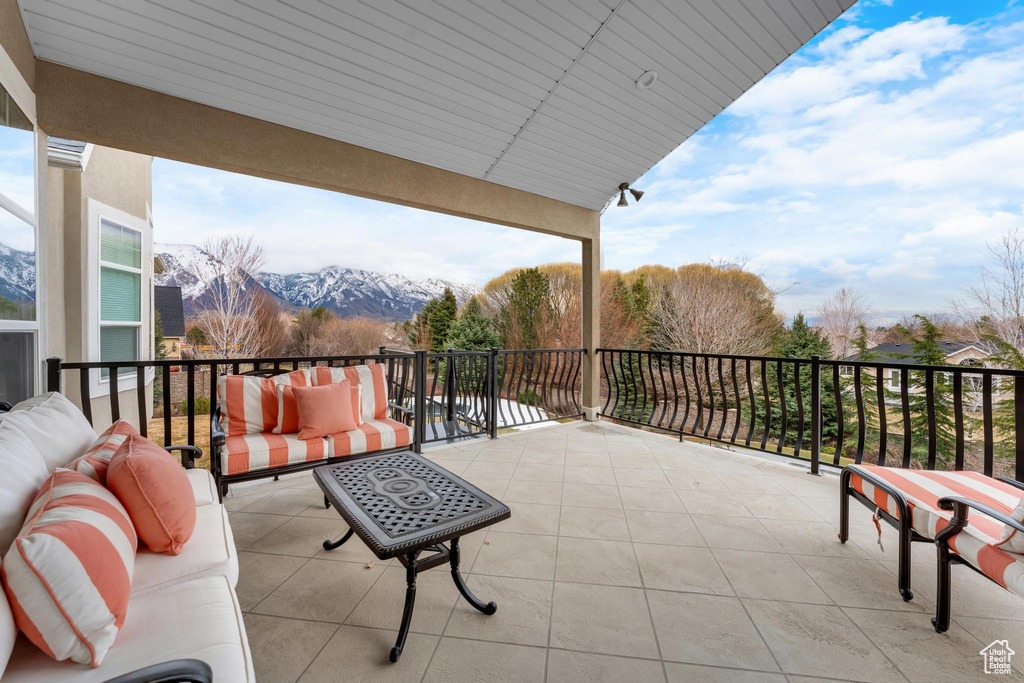 Balcony featuring a mountain view and an outdoor living space