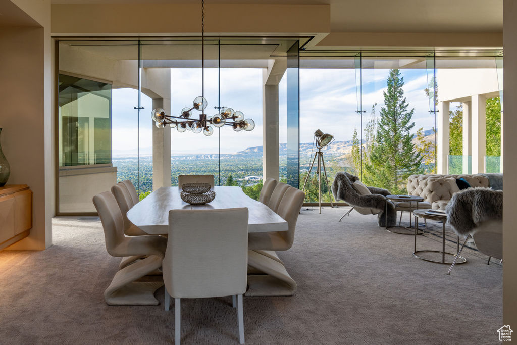 Carpeted dining room featuring a notable chandelier