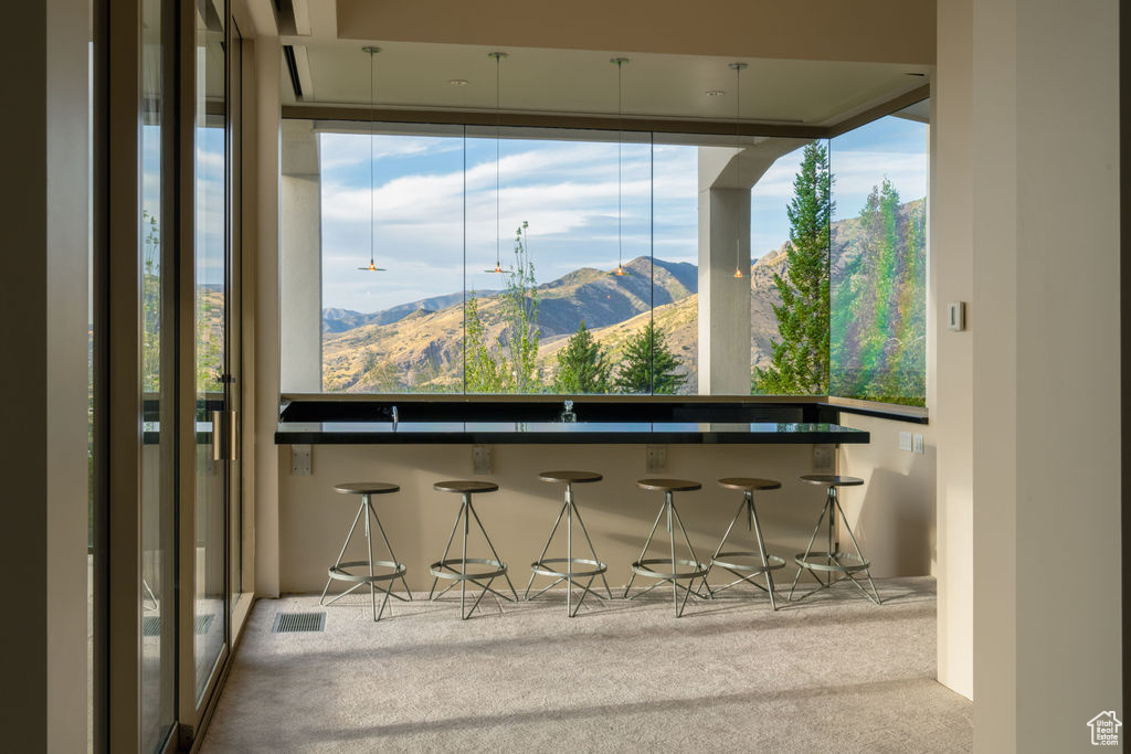 Interior space with light colored carpet and a mountain view