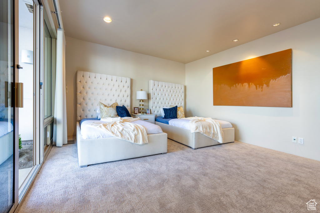 Bedroom with light colored carpet and access to exterior