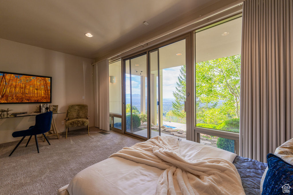 Bedroom with access to outside and light colored carpet