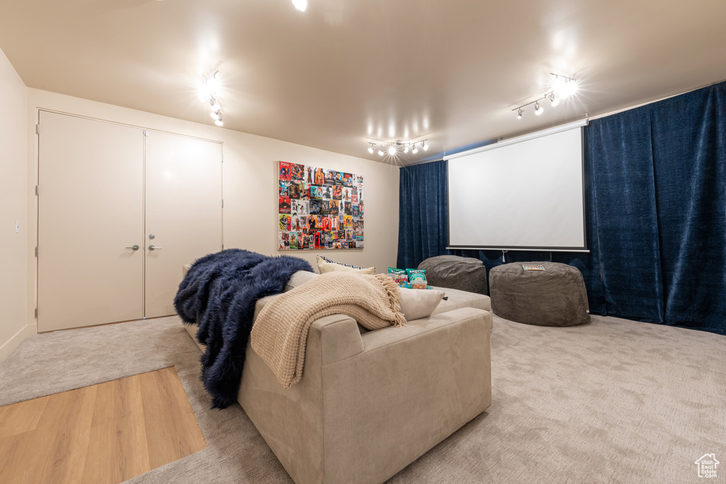 Carpeted home theater featuring track lighting