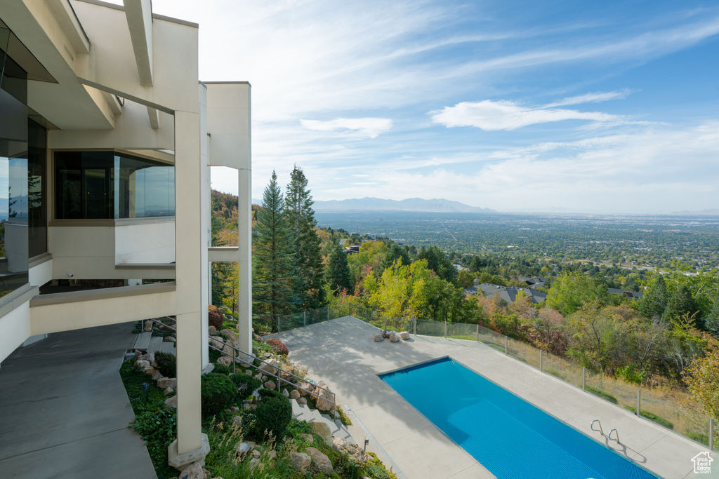 View of pool featuring a mountain view and a patio area