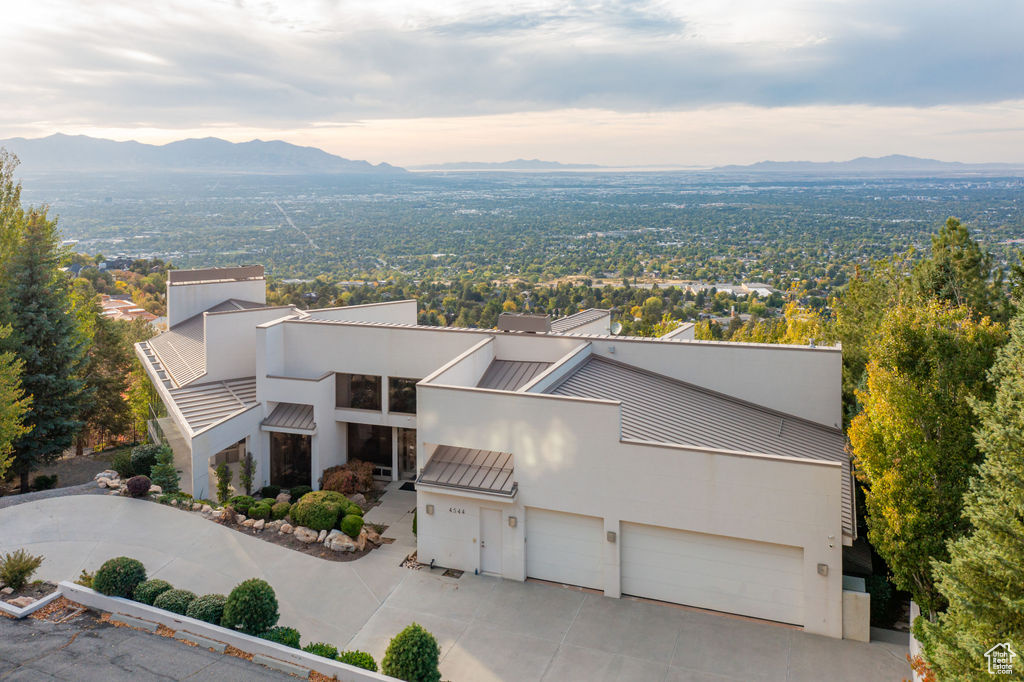 View of front facade with a garage and a mountain view