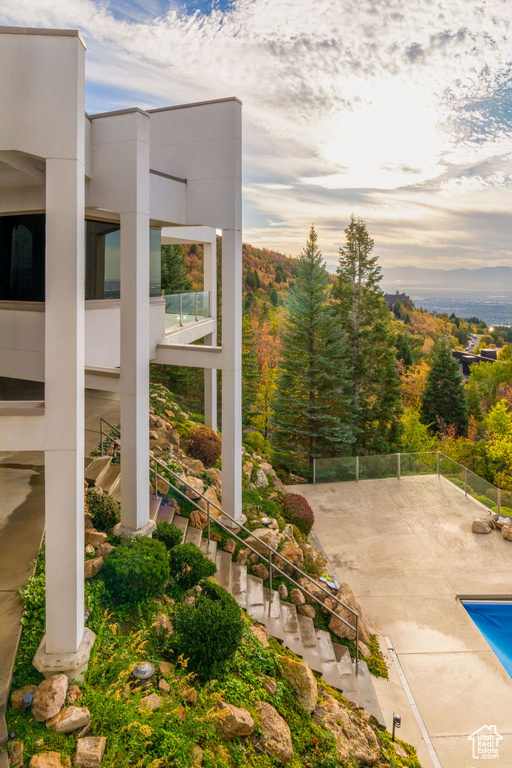 Patio terrace at dusk featuring a fenced in pool