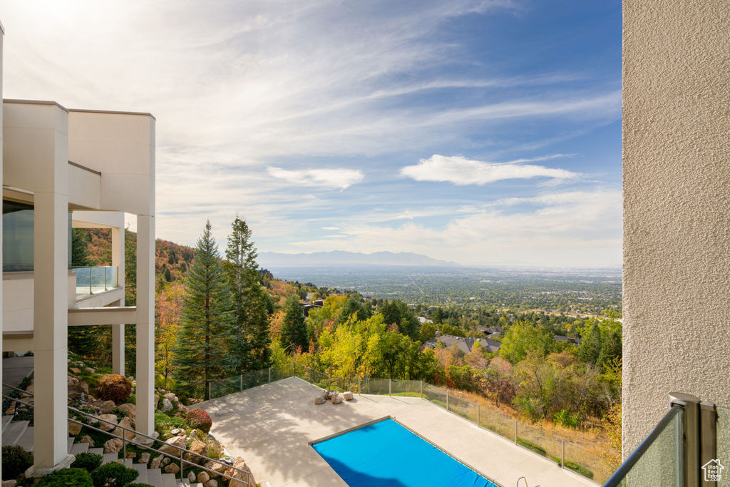 View of swimming pool with a mountain view and a patio area