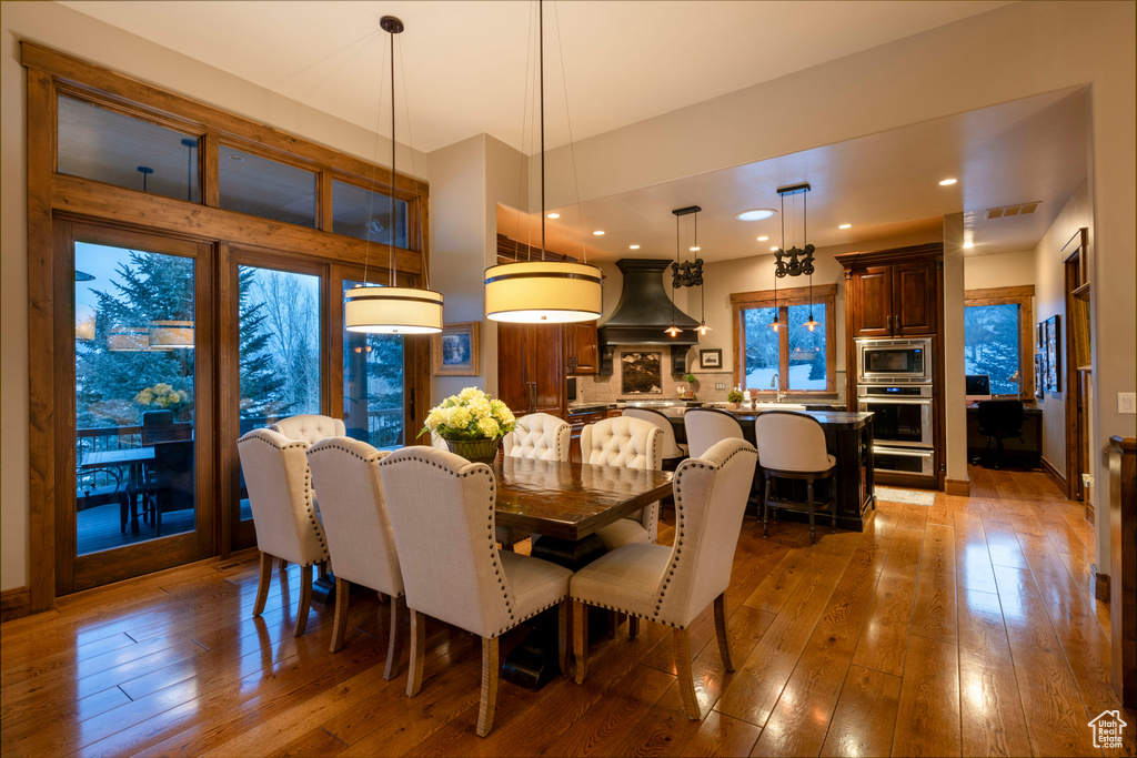 Dining space featuring hardwood / wood-style flooring and a healthy amount of sunlight