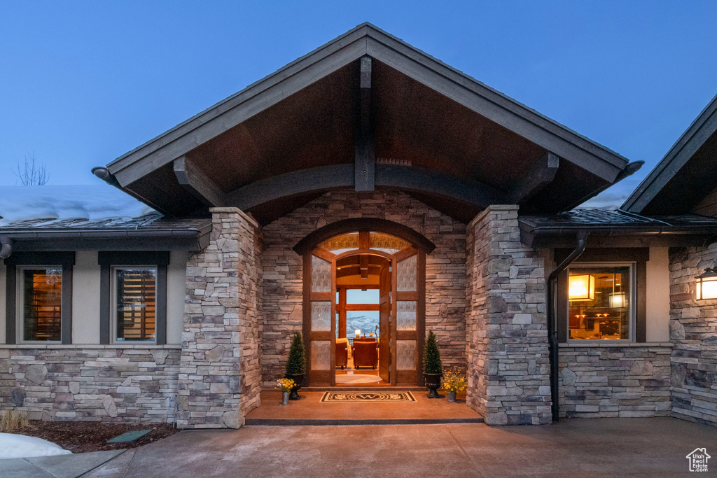 Exterior entry at dusk with french doors