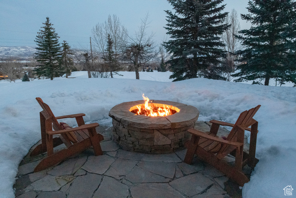 Snow covered patio with a fire pit
