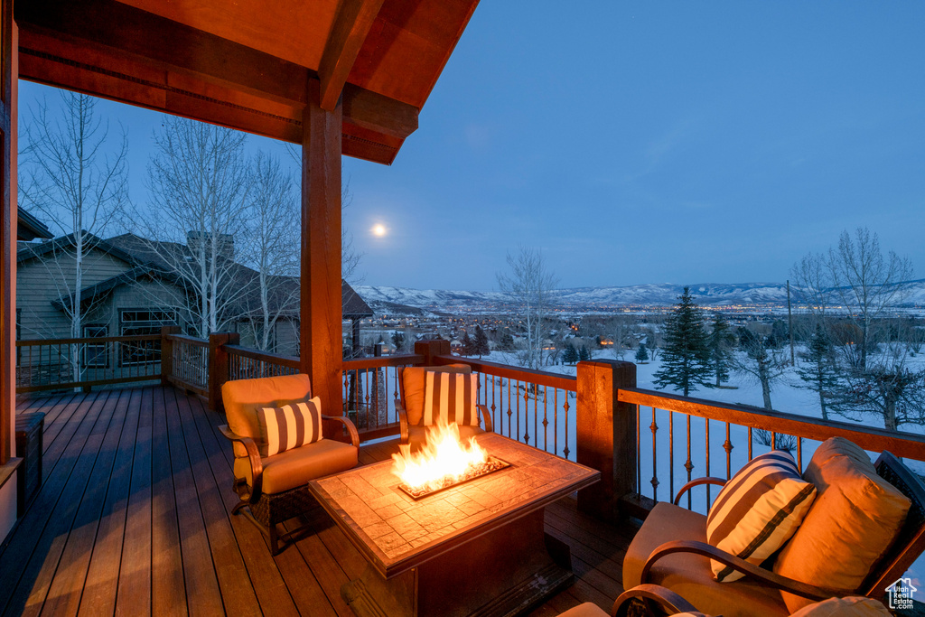 Snow covered deck with an outdoor fire pit