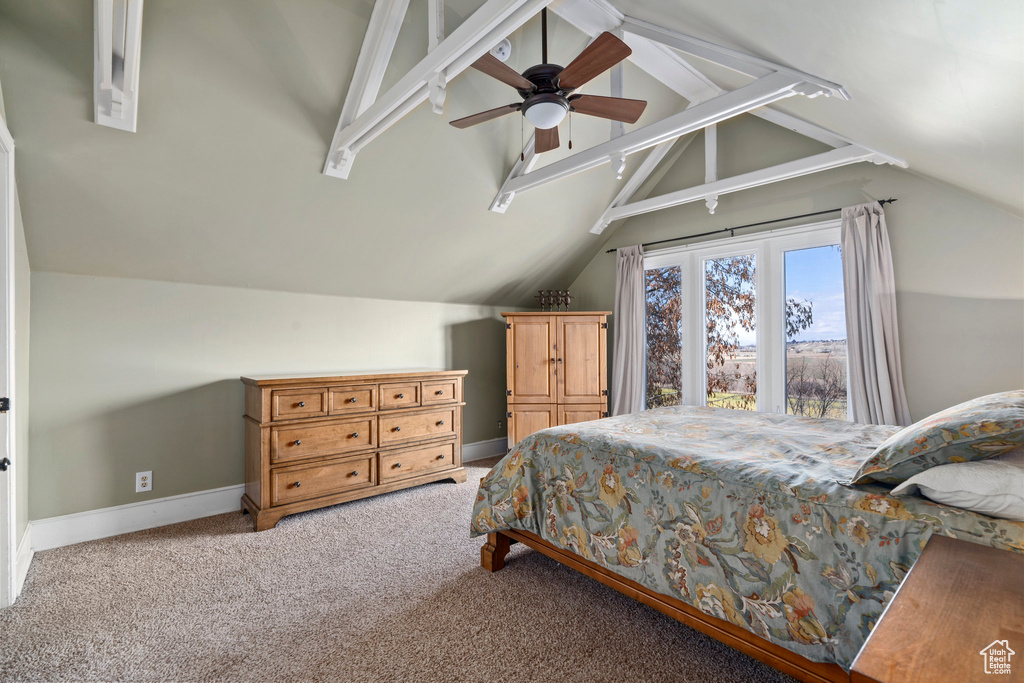 Bedroom with ceiling fan, light colored carpet, and lofted ceiling