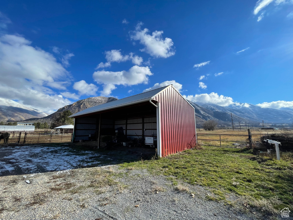 View of shed / structure with a mountain view, a rural view, and a carport