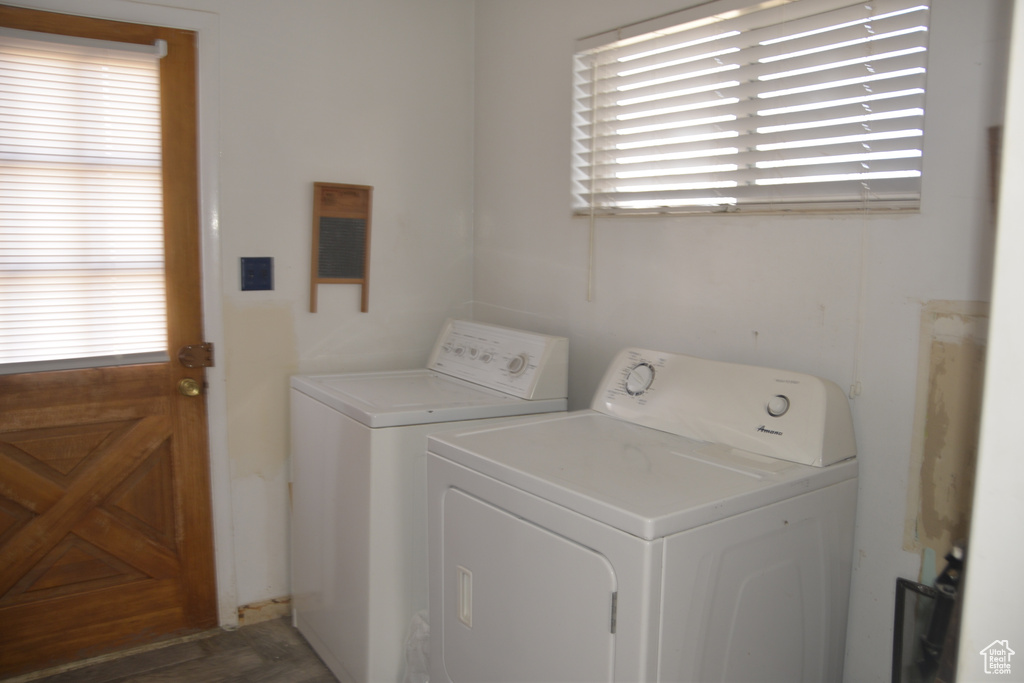 Washroom featuring plenty of natural light, dark hardwood / wood-style flooring, and independent washer and dryer