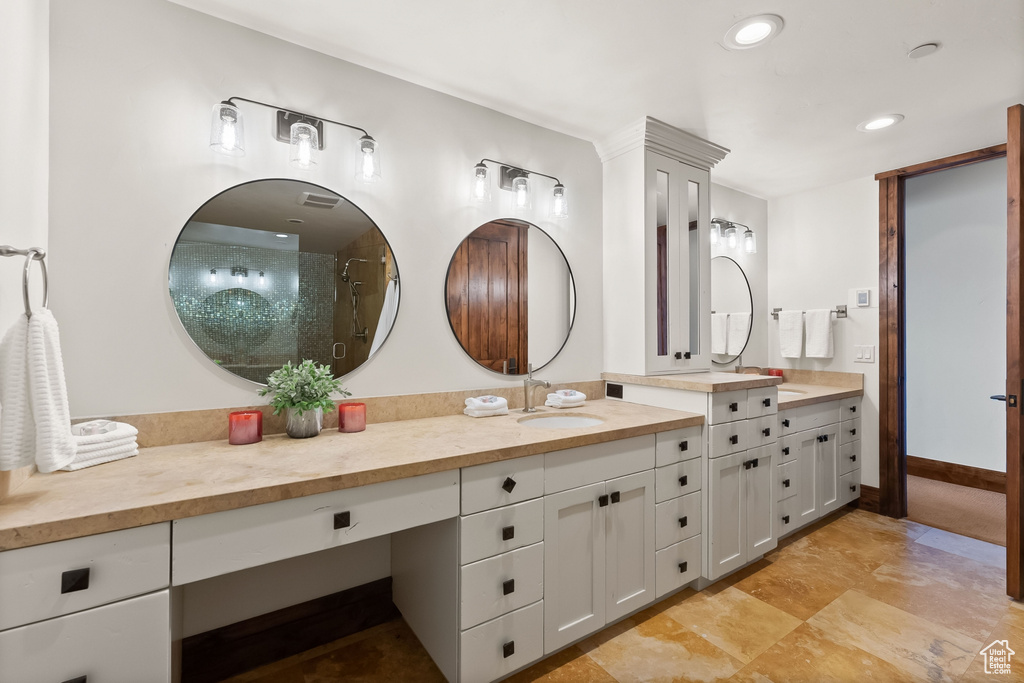 Bathroom featuring vanity with extensive cabinet space, tile flooring, and walk in shower