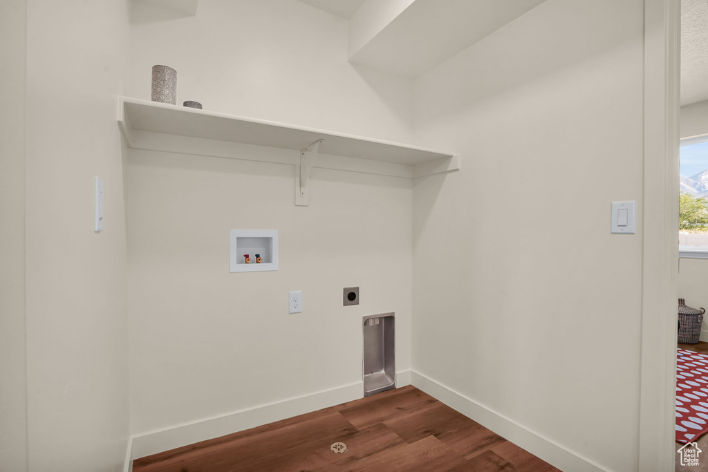 Washroom with washer hookup, dark hardwood / wood-style floors, and electric dryer hookup