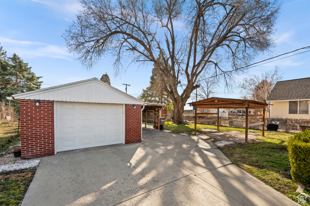 Garage with a yard and a carport