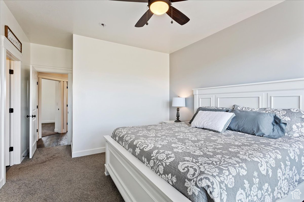 Bedroom featuring dark colored carpet and ceiling fan