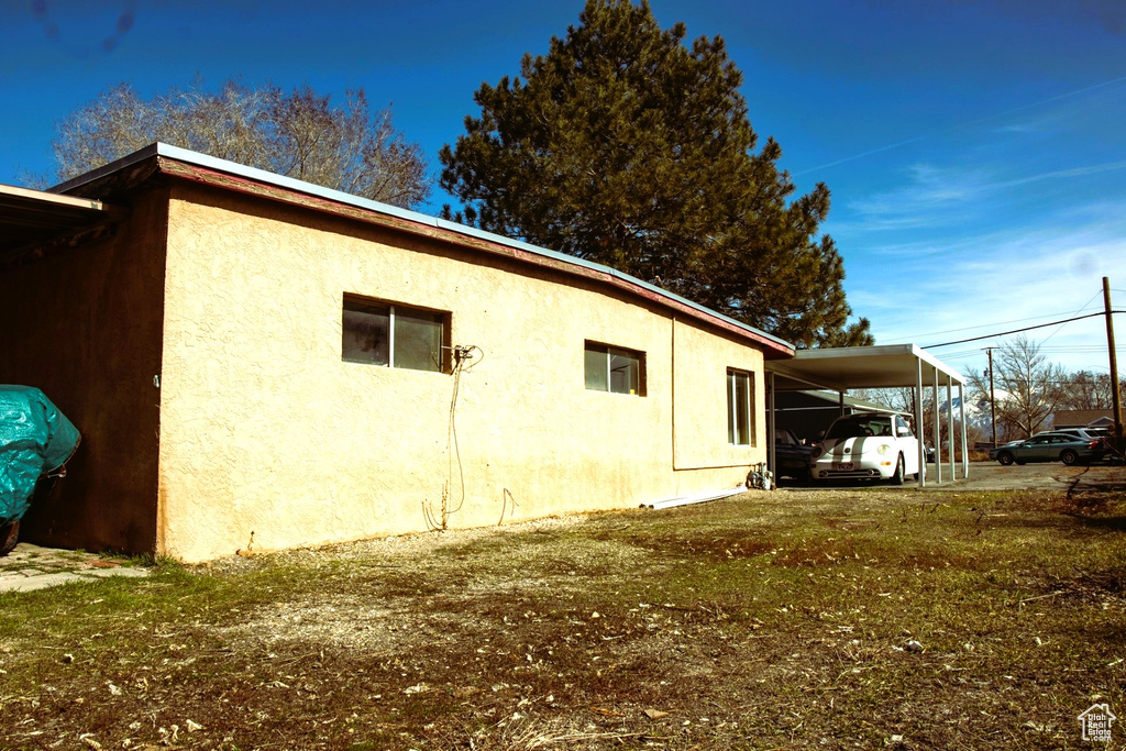 View of side of property featuring a carport