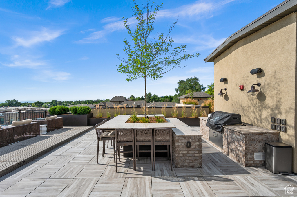 View of patio / terrace with grilling area, an outdoor hangout area, and exterior kitchen