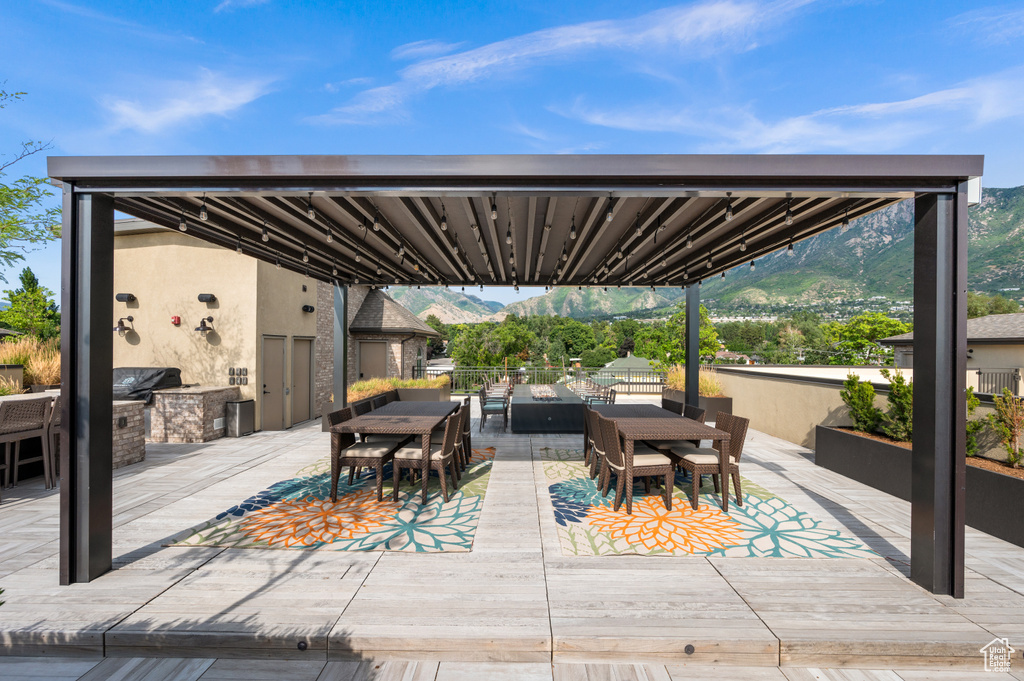 View of patio featuring area for grilling, a mountain view, and an outdoor kitchen