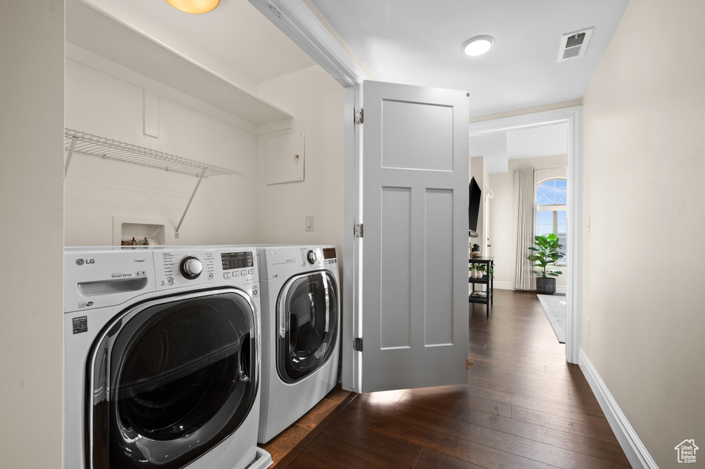 Laundry room with separate washer and dryer, dark hardwood / wood-style flooring, and hookup for a washing machine