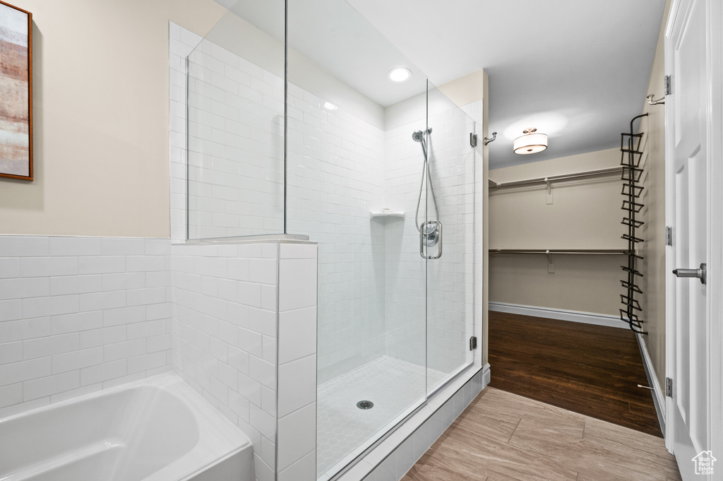 Bathroom featuring hardwood / wood-style floors and independent shower and bath