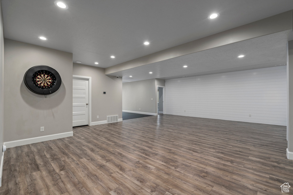 Basement with dark hardwood / wood-style flooring