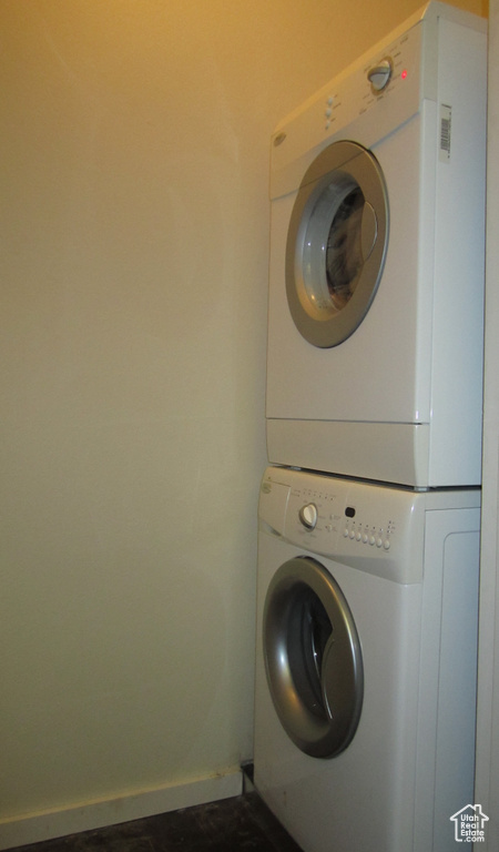 Washroom featuring stacked washer and clothes dryer