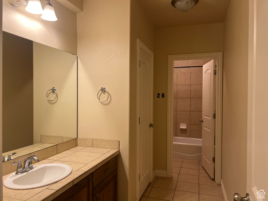 Bathroom with vanity, shower / washtub combination, and tile floors