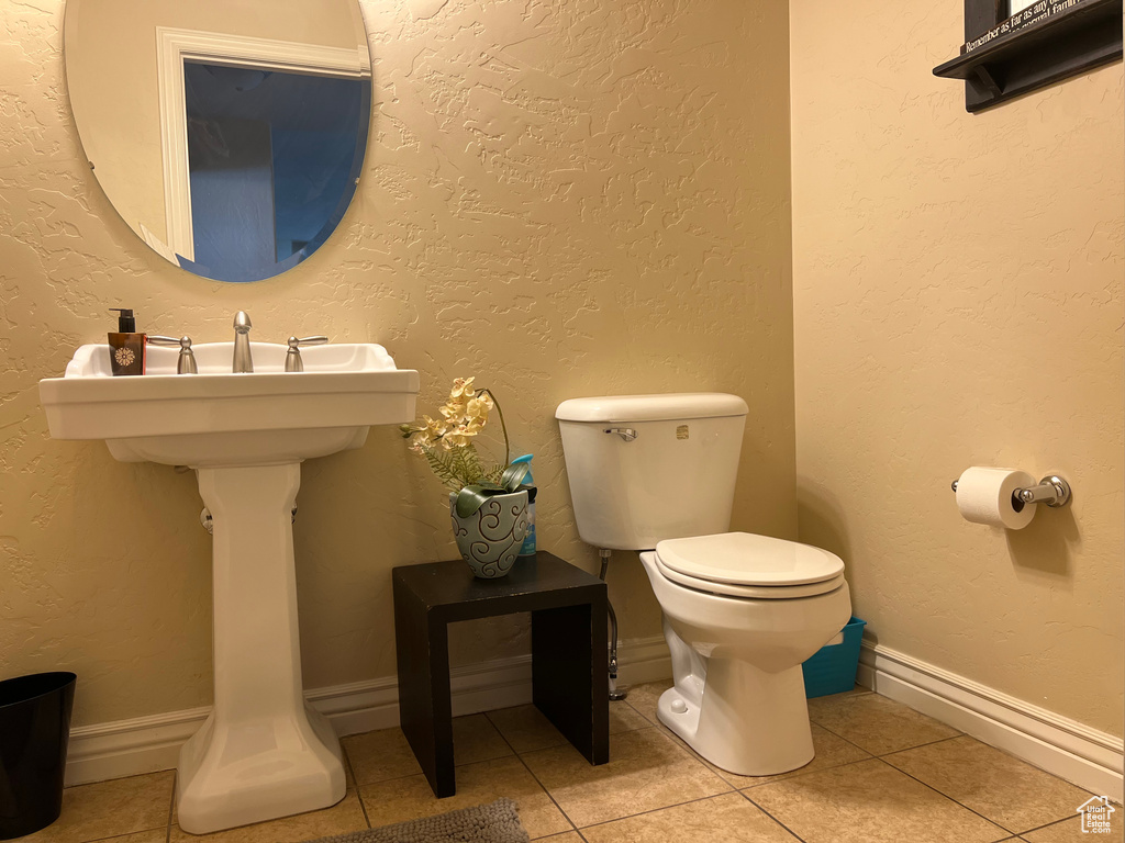 Bathroom with toilet and tile floors