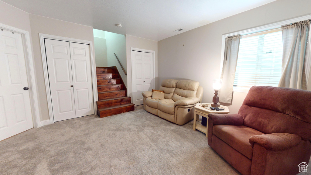 Sitting room featuring light colored carpet