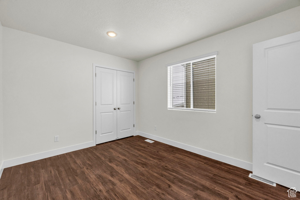 Spare room featuring dark hardwood / wood-style floors