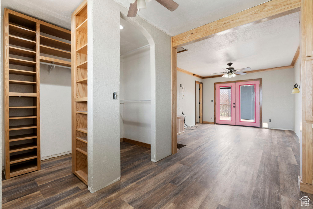 Interior space with french doors, ceiling fan, and dark wood-type flooring