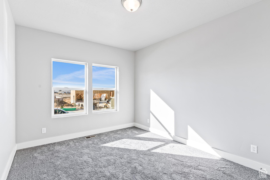 Empty room featuring light carpet